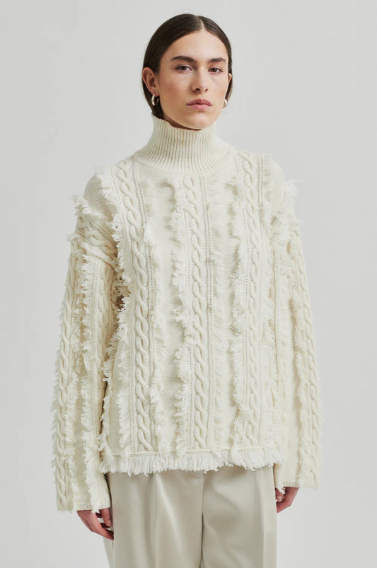 cream turtleneck jumper with fringe and cable detail model shot