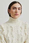 cream turtleneck jumper with fringe and cable detail close up