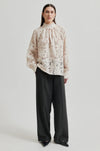 floral lace blouse on sheer background with high neck and buttoned cuffs model shot 