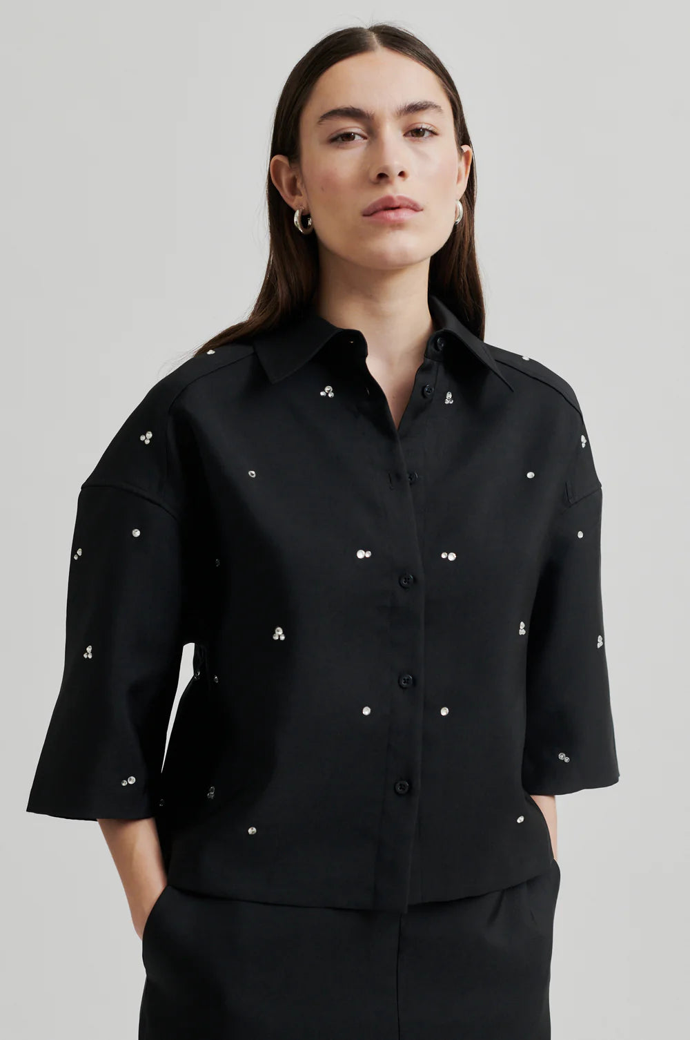 short sleeved cropped black boxy shirt with rhinestone covering model shot