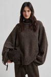 Person wearing a brown oversized sweater on a plain background from Second Female