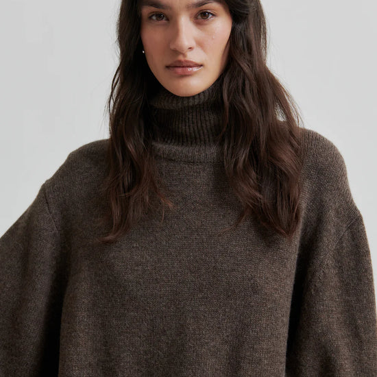 Turtleneck wool mix brown jumper with rib detailing close up model