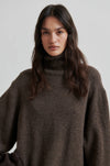 Turtleneck wool mix brown jumper with rib detailing close up model