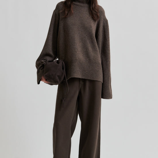 Woman wearing a brown outfit with a sweater and pants on a white background from Second Female
