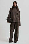 Woman wearing a brown outfit with a sweater and pants on a white background from Second Female