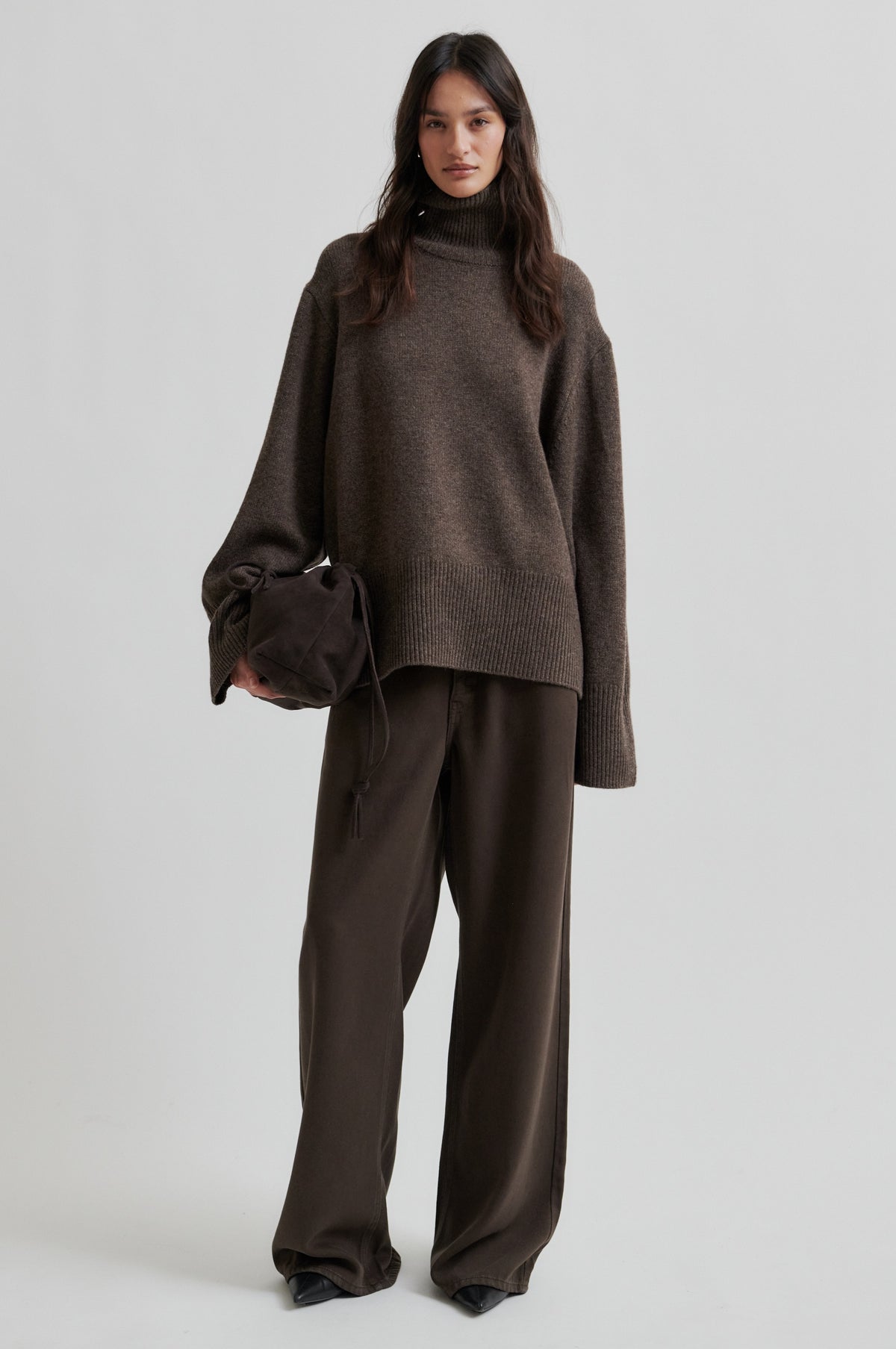 Woman wearing a brown outfit with a sweater and pants on a white background from Second Female