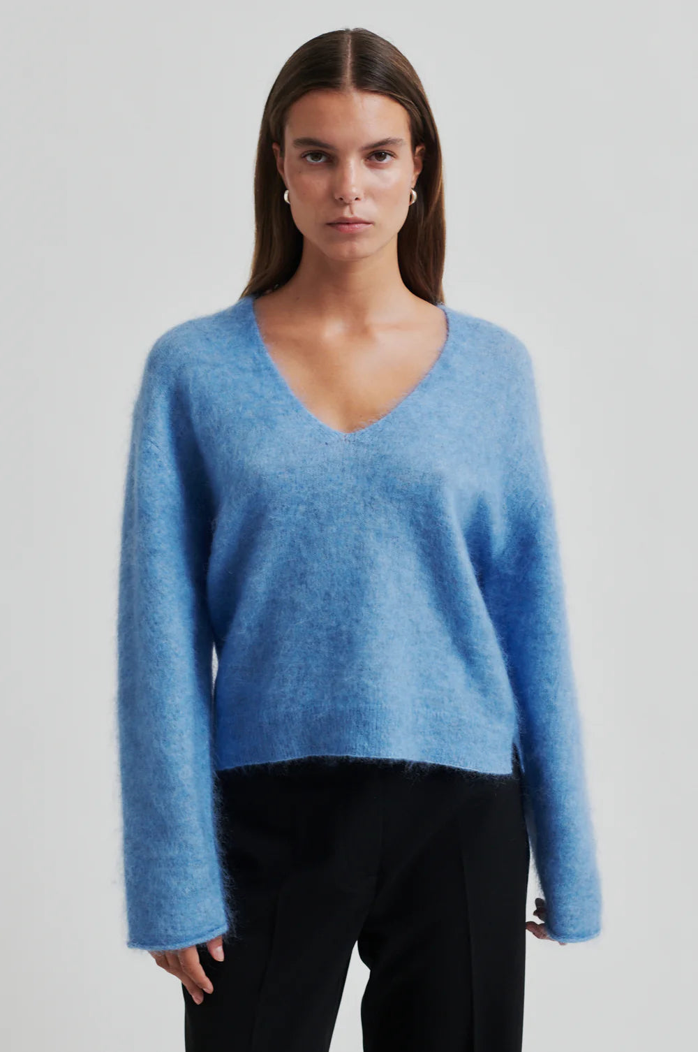 blue v neck knit with long sleeves and side splits  model shot