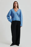 blue v neck knit with long sleeves and side splits  model shot