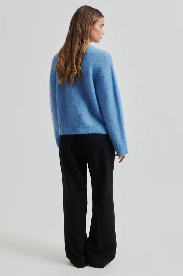 blue v neck knit with long sleeves and side splits rear view 