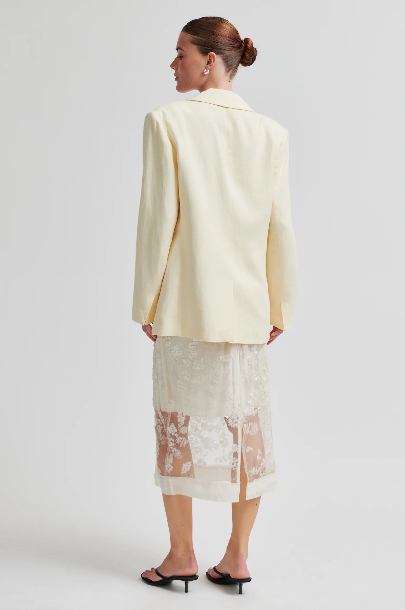Rear view of Cream blazer worn with lace detail skirt from Second Female