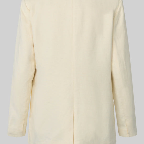 Rear view of cream blazer on a light gray background