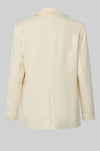 Rear view of cream blazer on a light gray background