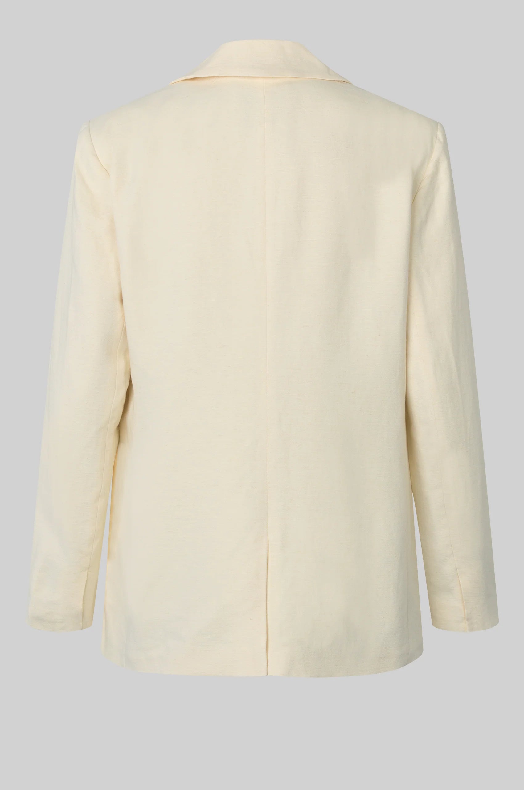 Rear view of cream blazer on a light gray background