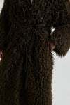 Close-up of a brown textured coat with a blurred background