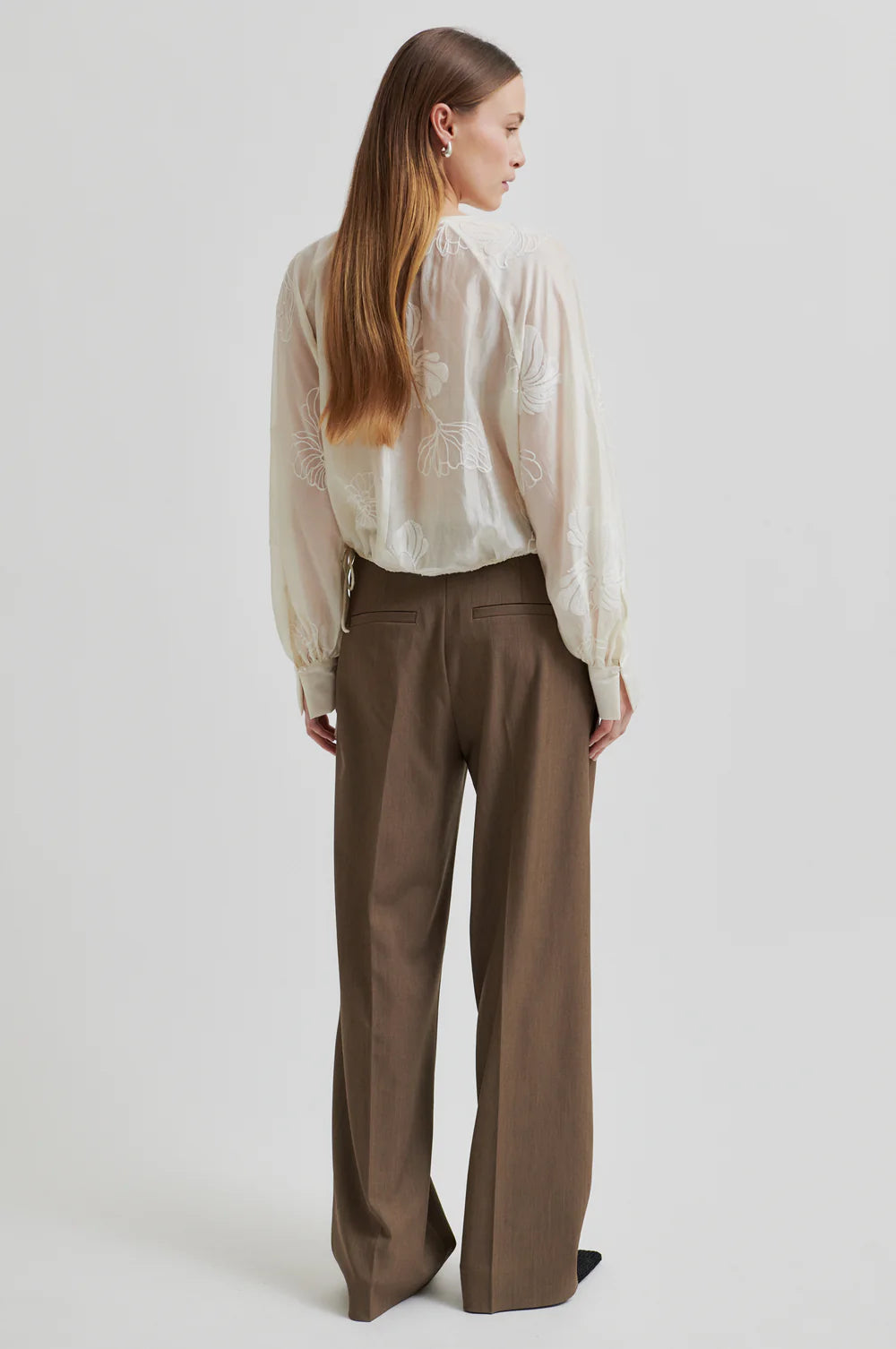 round neck ecru blouse with tonal floral print with long cuffed sleeves rear view