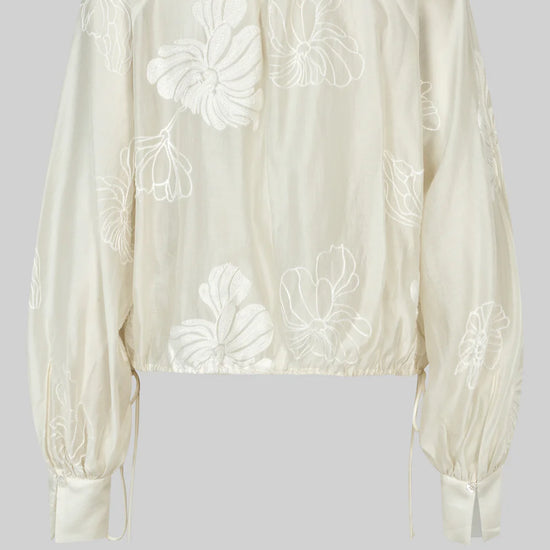 round neck ecru blouse with tonal floral print with long cuffed sleeves rear view