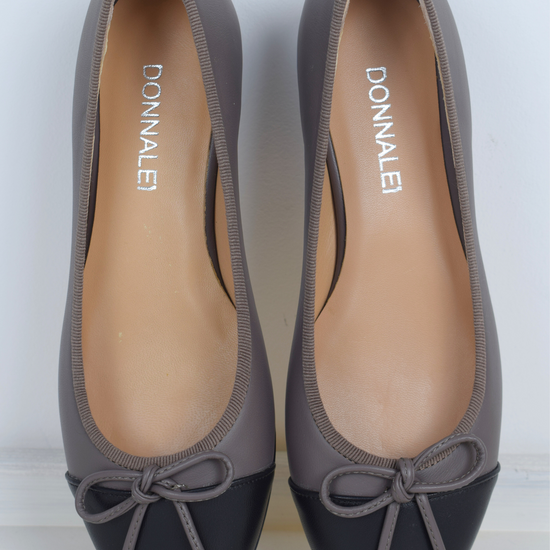 Taupe ballet pump with black toe and bow detail