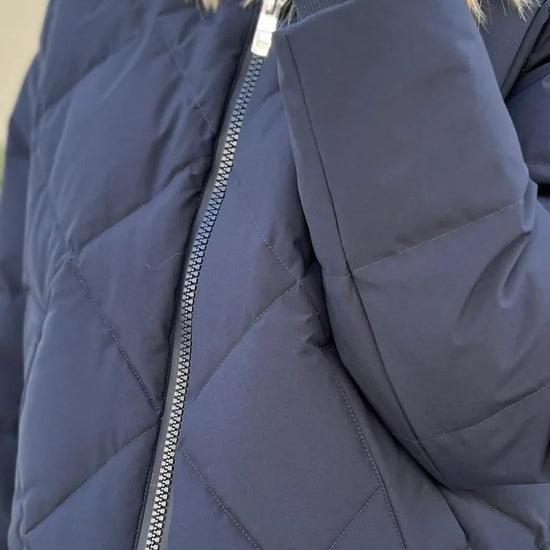 navy blue down jacket with diamond stitch design, zipped away hood and side pockets  close up