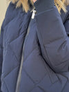 navy blue down jacket with diamond stitch design, zipped away hood and side pockets  close up