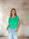 Model shot of green top with flutter sleeves from Sirens