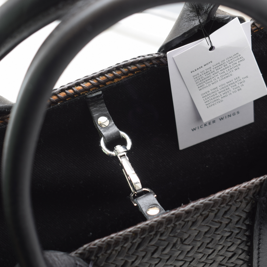 Hand woven black tote bag with leather handles