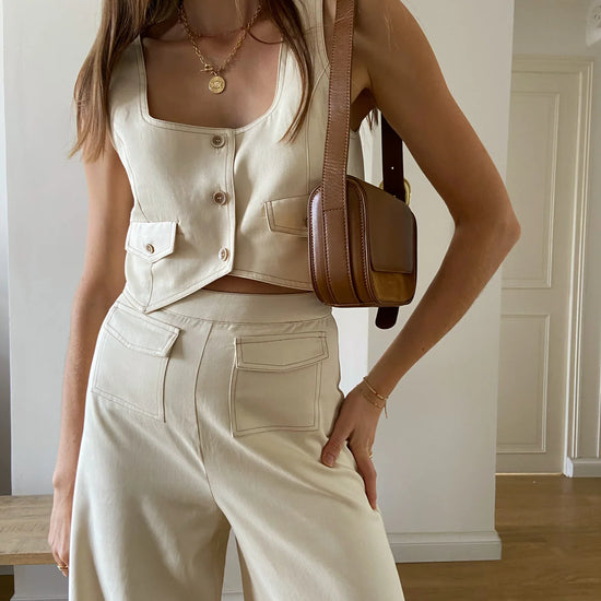 Cream cropped waistcoat with button fastening and two front patch pockets