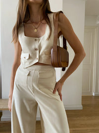 Cream cropped waistcoat with button fastening and two front patch pockets