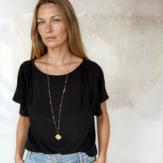Black flutter sleeve top worn with blue denim