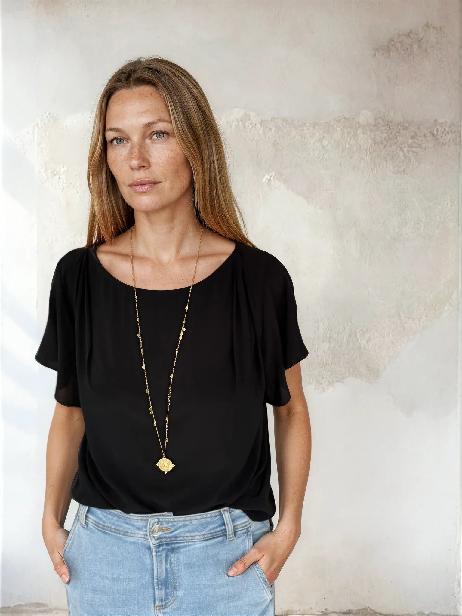 Black flutter sleeve top worn with blue denim