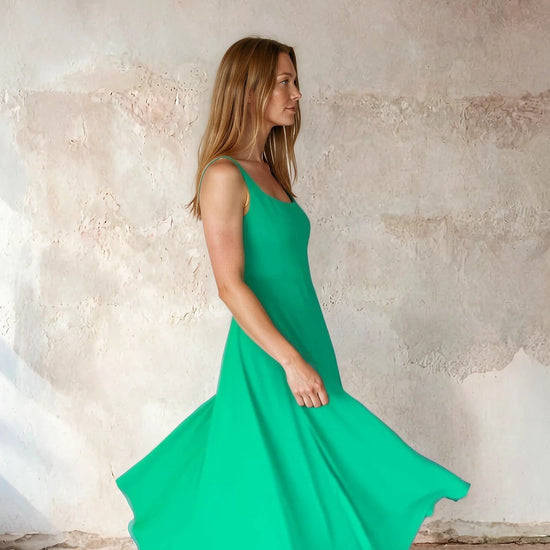 Model shot of green fit and flare dress from Sirens