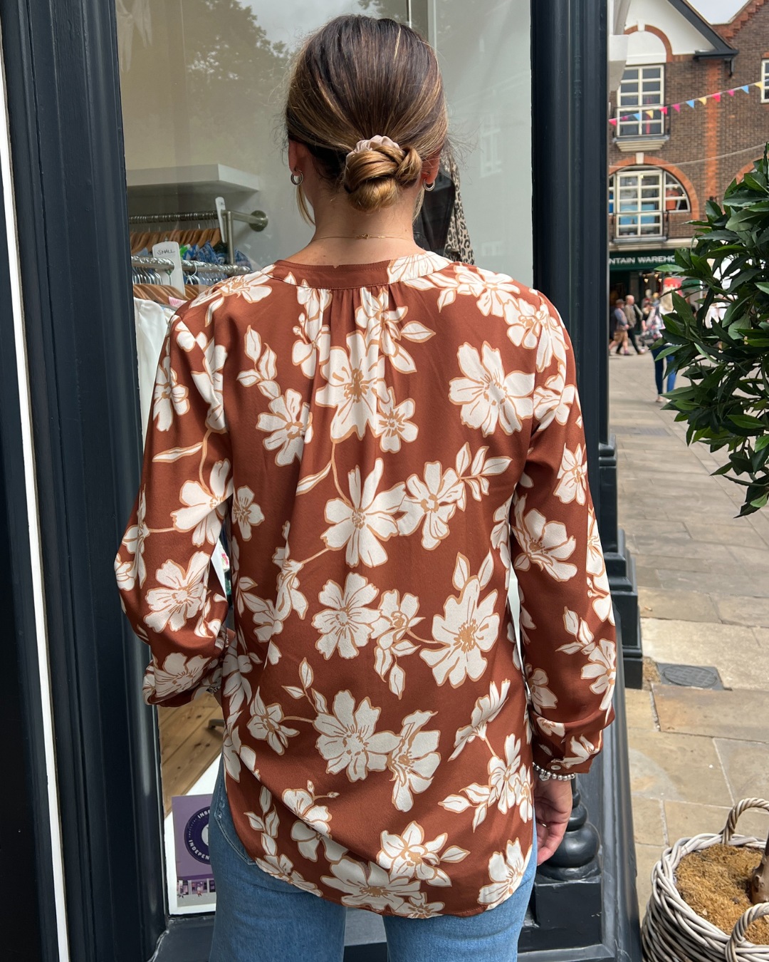 A tan top with white flowers 