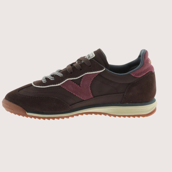 A dark brown suede and mesh sneaker with burgundy accents, featuring a cream midsole and a gum outsole, shown from a side profile on a light gray background.