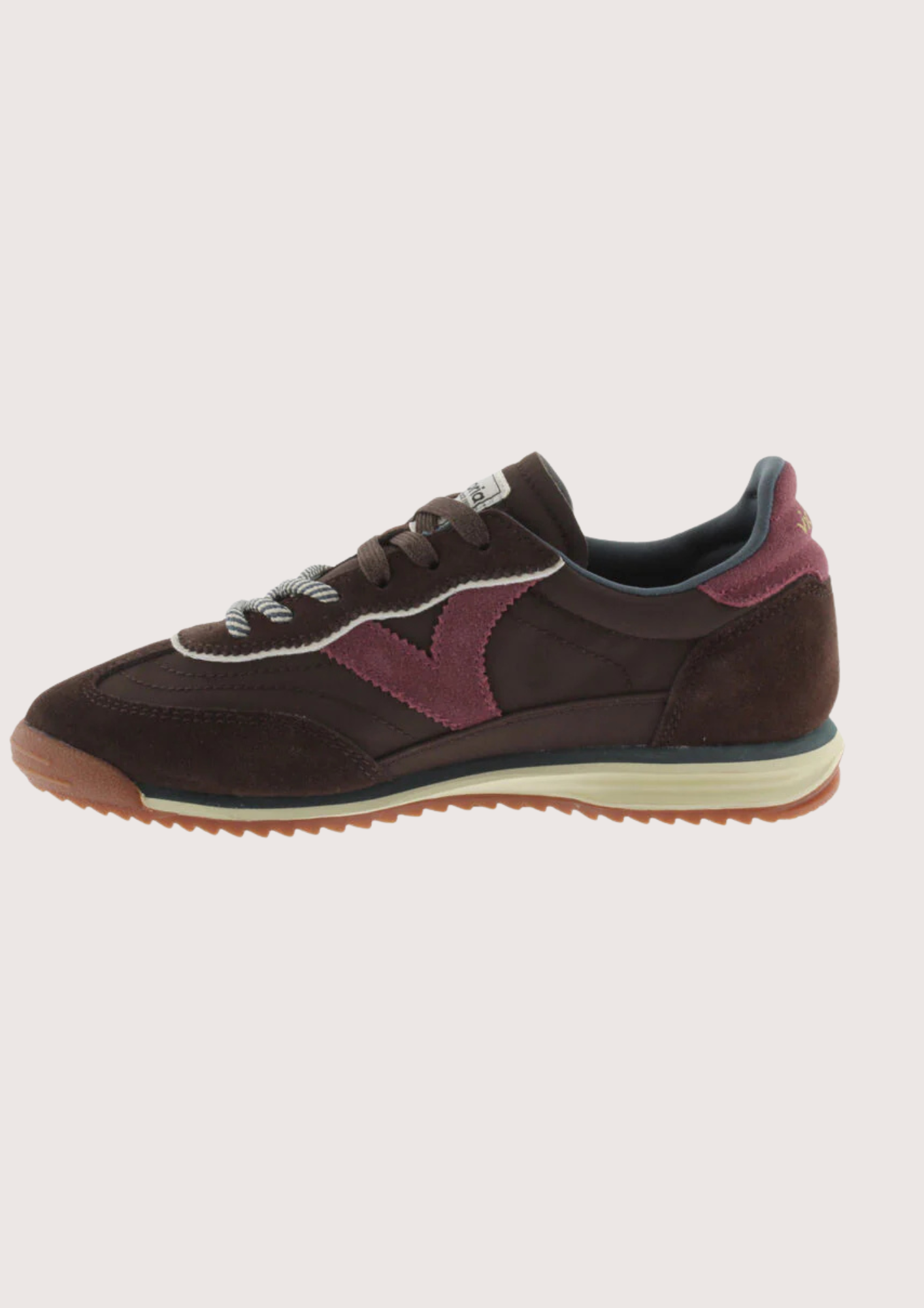 A dark brown suede and mesh sneaker with burgundy accents, featuring a cream midsole and a gum outsole, shown from a side profile on a light gray background.