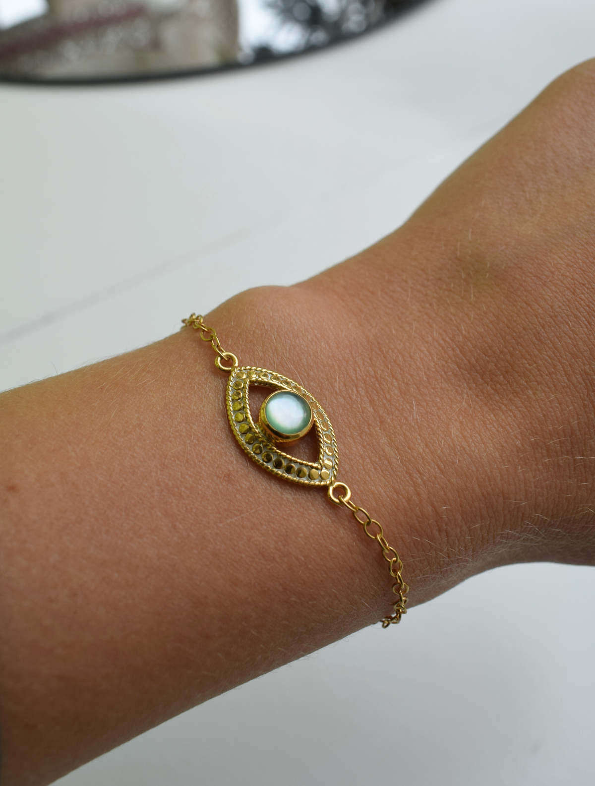 Gold evil eye bracelet with green opal stone 