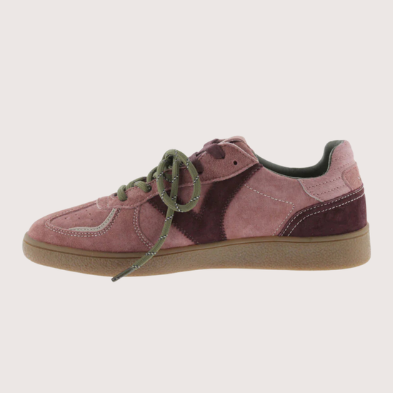 A low-top sneaker in dusty pink and dark burgundy suede with olive green laces and a gum sole, shown in profile against a light beige background.