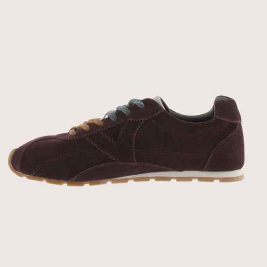 Brown suede sneaker with beige sole on a white background