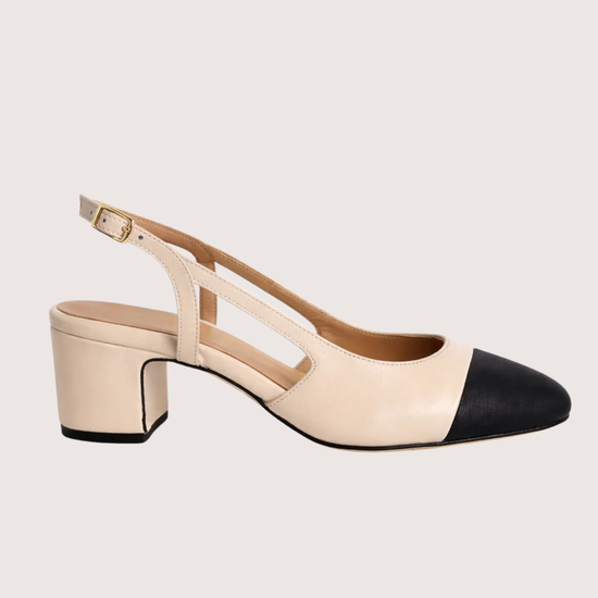 cream heeled shoe with a slingback on a white background.