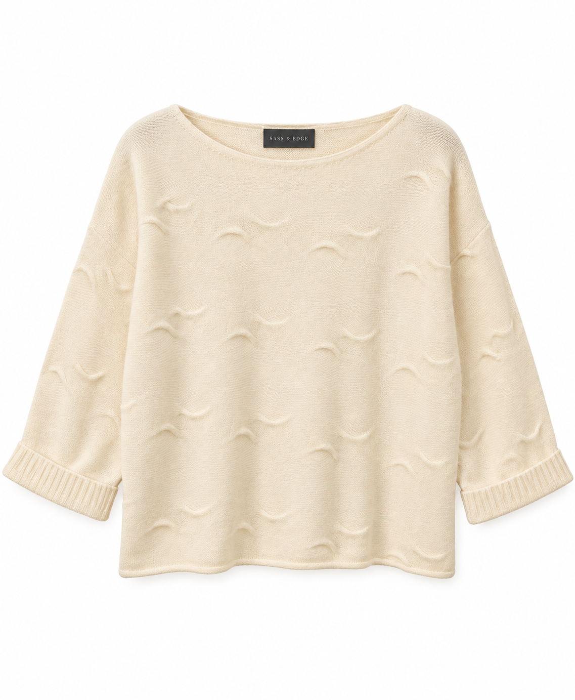 Flat lay image of a white cashmere knit, with wave detailing in the stitching and shorter length sleeves
