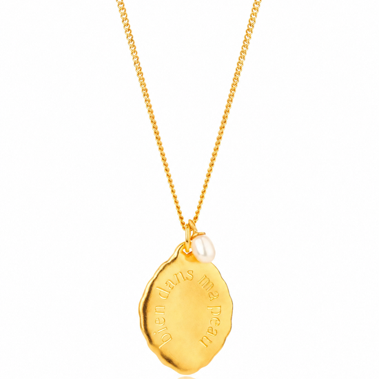 close up of a gold pendant necklace 