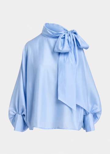 A light blue satin blouse with a large bow at the high neck and gathered balloon sleeves, shown on a plain light gray background.