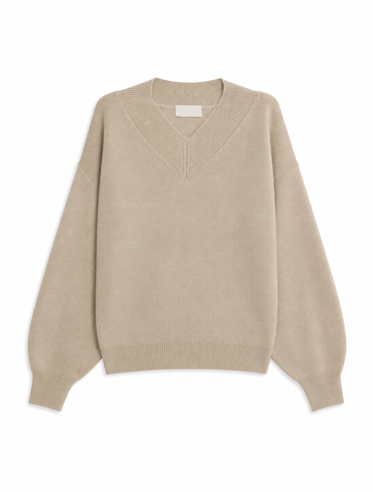 A light beige knit sweater with a V-neck and long balloon sleeves, shown flat against a plain white background.