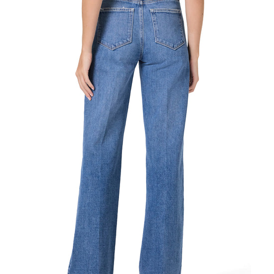 Blue jeans worn by a person on a white background