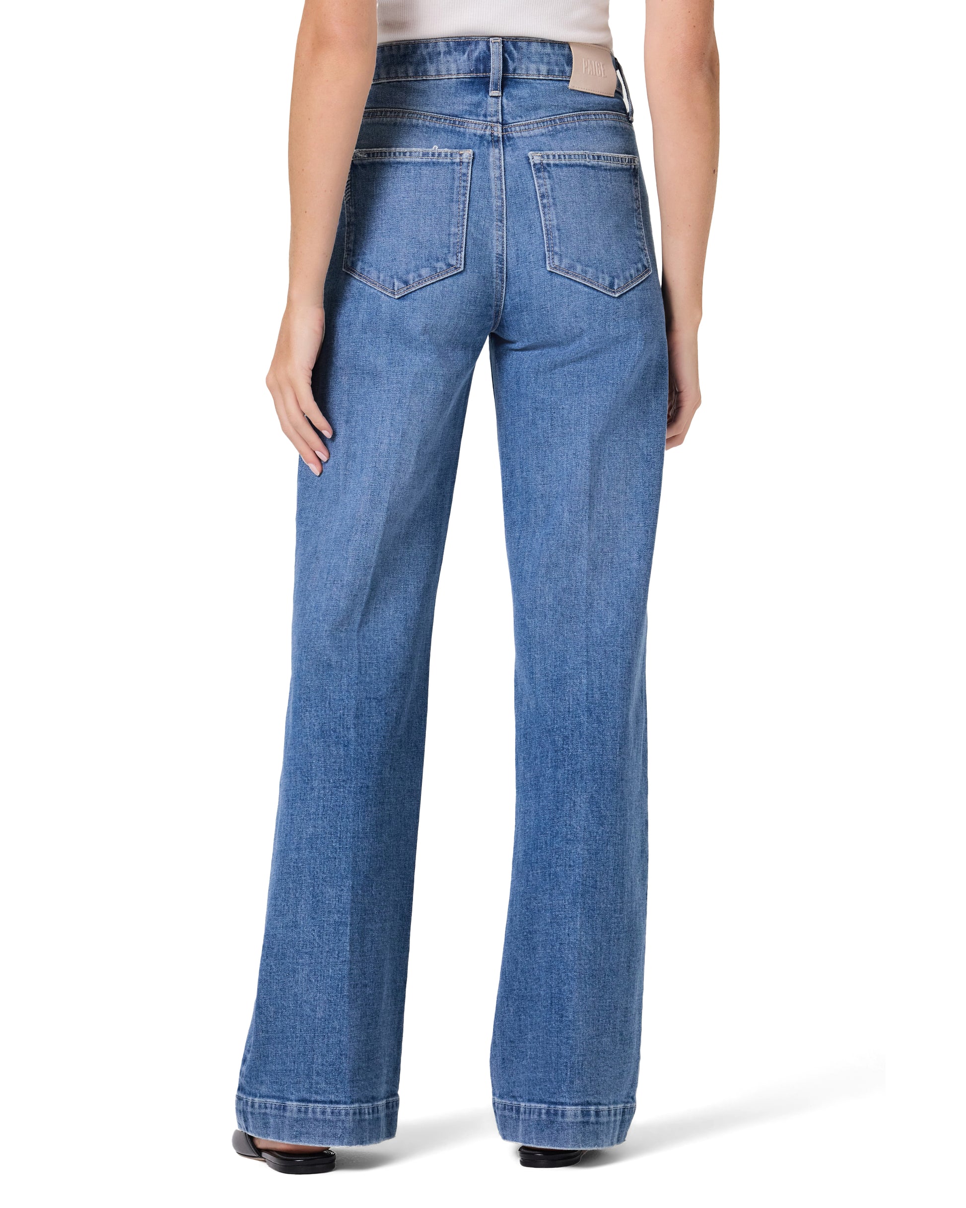 Blue jeans worn by a person on a white background