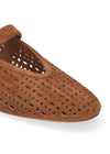 Brown perforated flat shoe on a white background