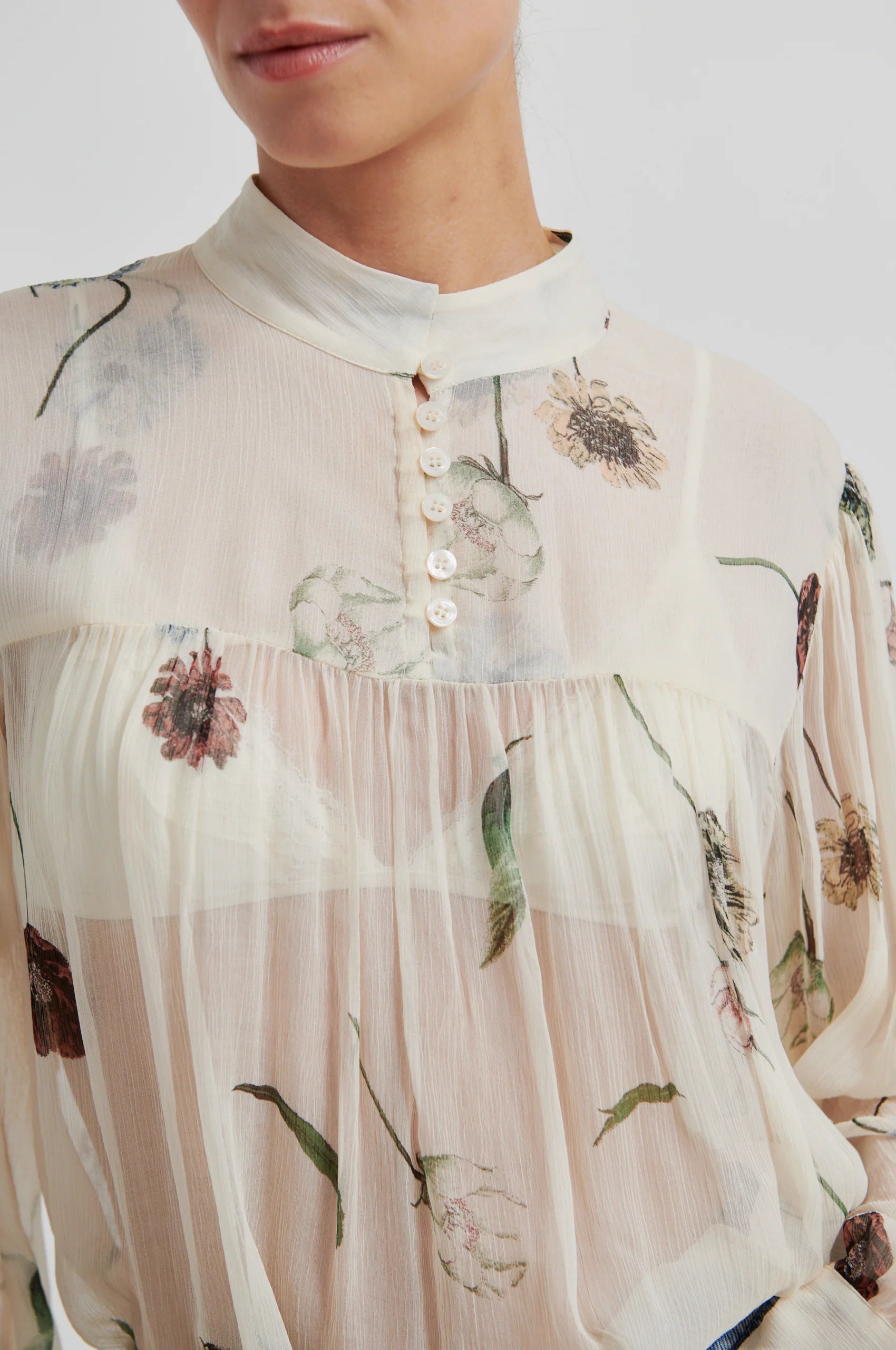 Close-up of a floral-patterned blouse with a neutral background from Second Female