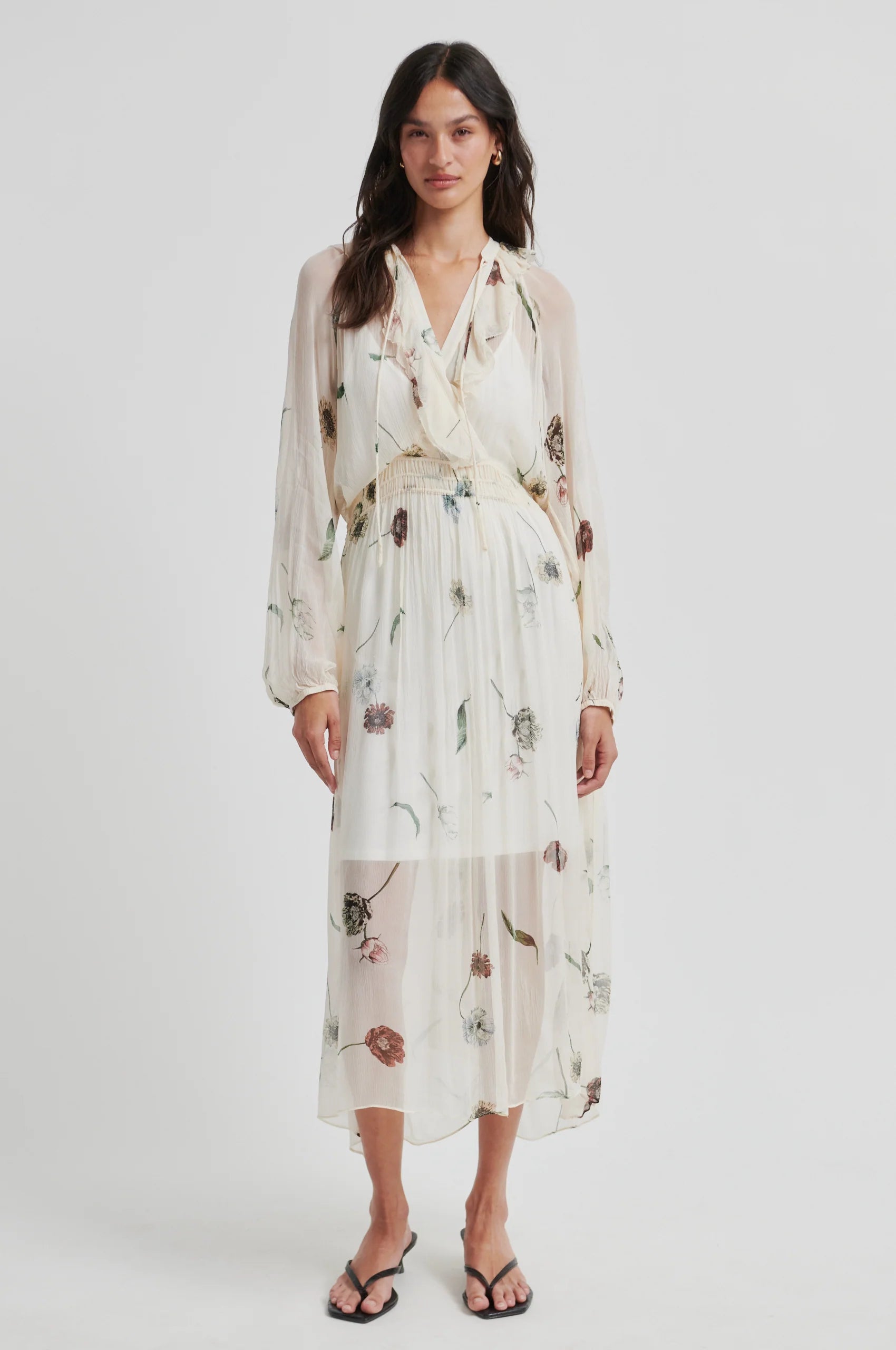 Woman wearing a floral dress on a white background