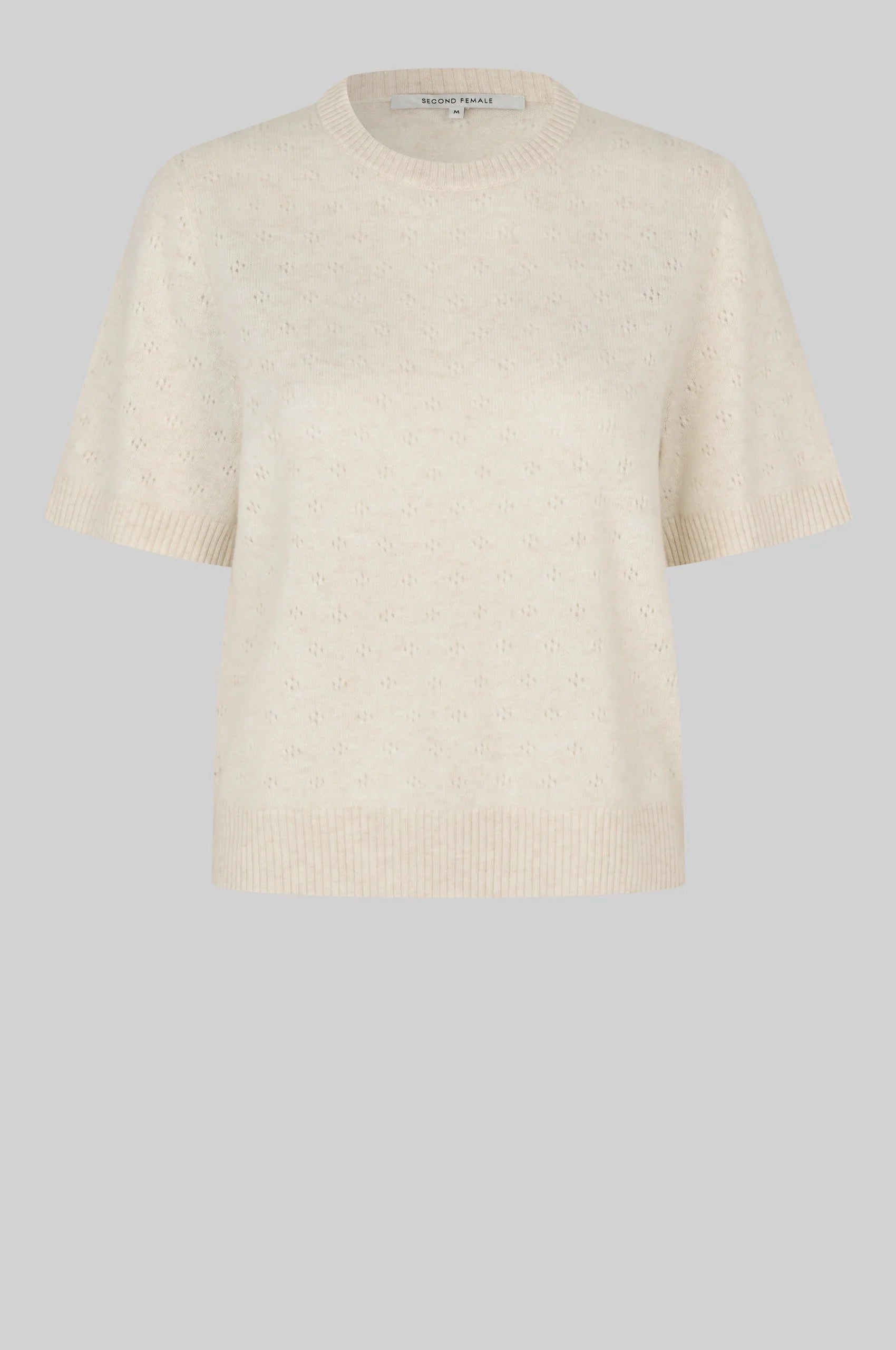 Beige knitted sweater on a light gray background from second female