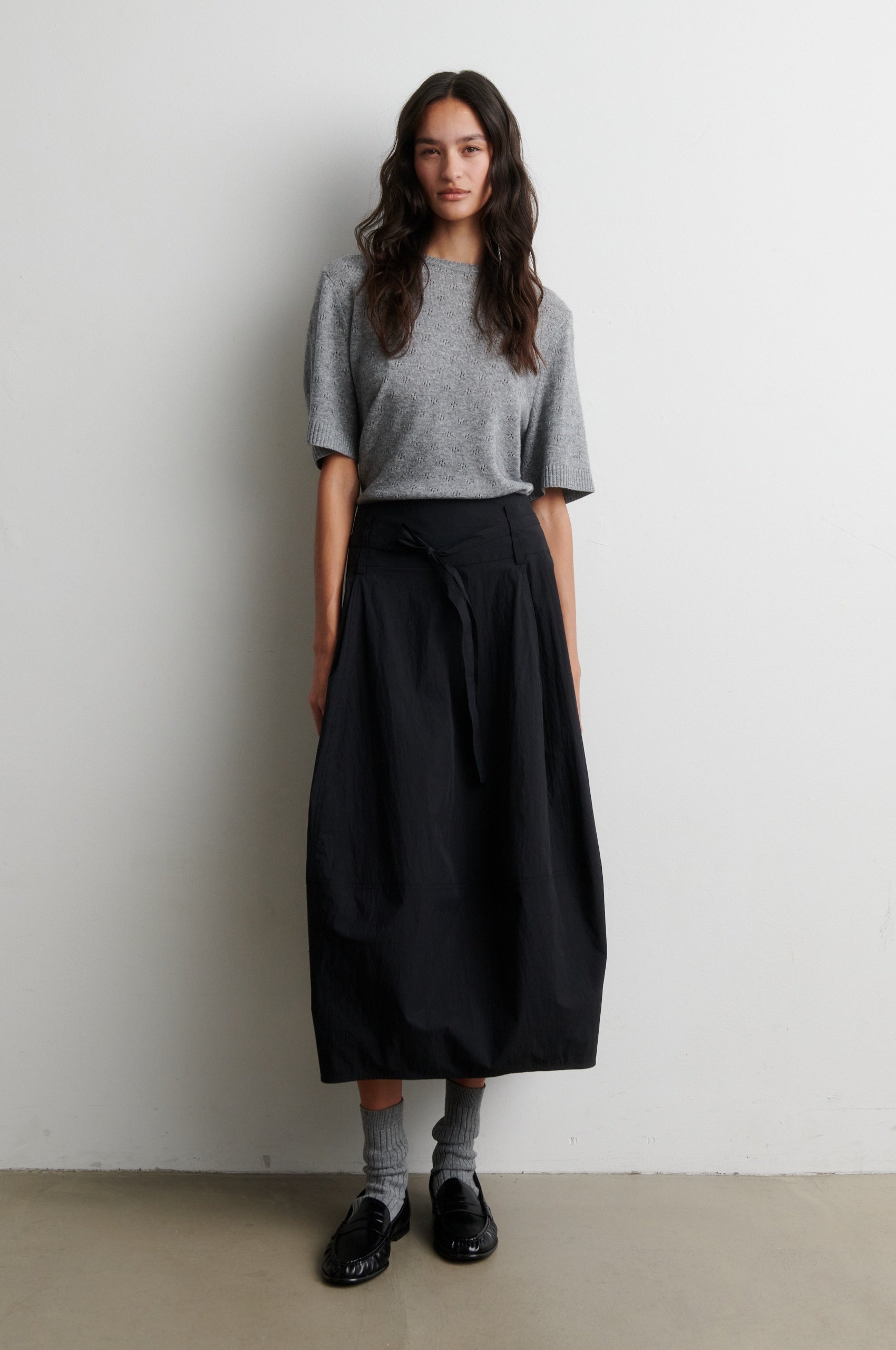 Short sleeved cashmere blend grey knit worn with a black skirt from Second Female