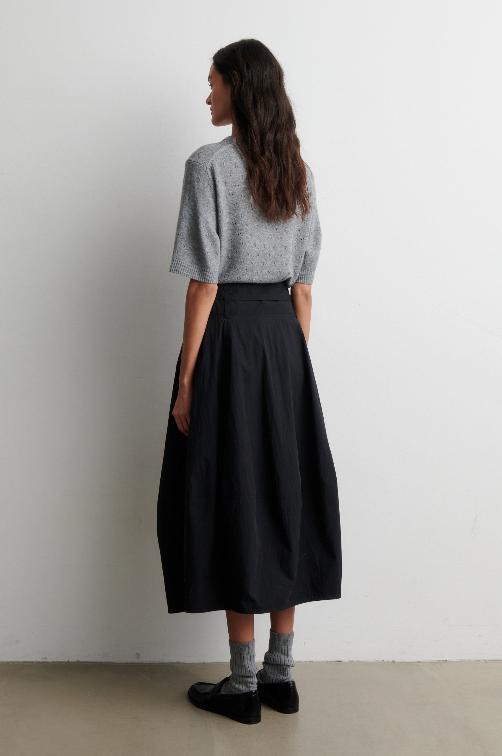 Rear view of grey cashmere blend short sleeve knit worn with black skirt from Second Female