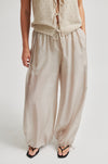 Beige sleeveless top and wide-leg pants on a white background from Second Female